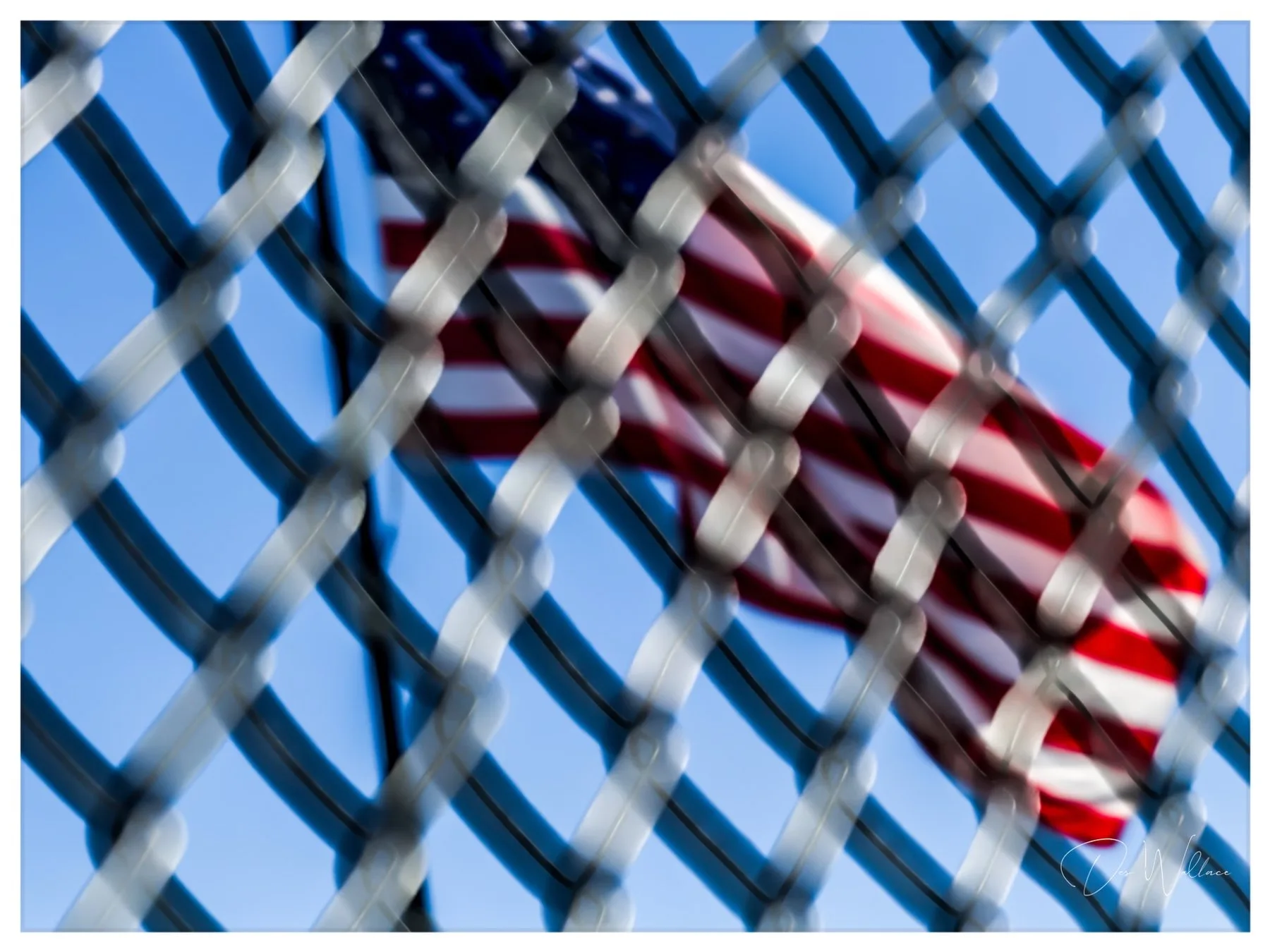 American flag through fence